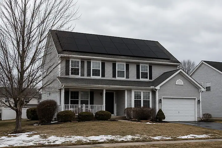 A two-storey suburban home with rooftop solar panels.